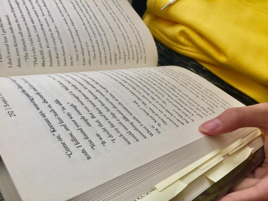 A student enjoys their time by reading a book, not for class but for fun. This activity is exactly what Pines lunchtime book club will aim to promote.