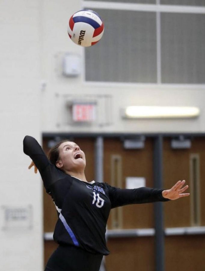 Claudia Kieda, senior volleyball player and track runner, prepares to spike the ball during a volleyball match. Kieda says she enjoys being a multi-sport athlete because “it’s just fun to be involved in something constantly because each sport has a different season.”