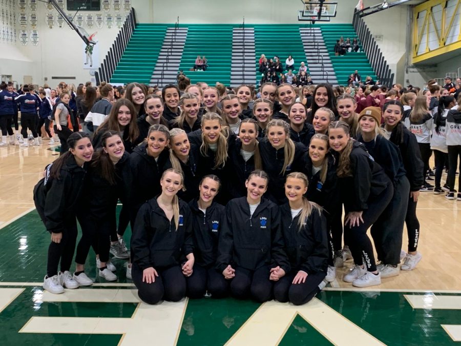 The+Poms+team+stands+together+after+winning+first+place+at+the+Stevenson+Invite.+The+Poms+team+has+high+expectation+after+returning+as+State+Champions+for+two+consecutive+years.+