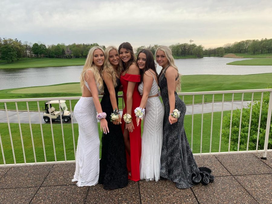 Tess Vages, senior, posing with her friends at her sophomore year prom. This year, despite all the changes, Vages says she actually prefers the format of the new dance to the old.  