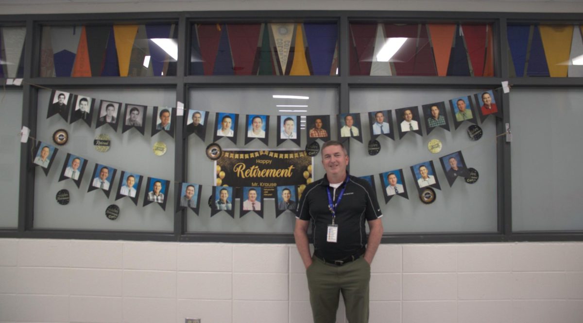 Carl+Krause%2C+college+and+career+counselor+stands+outside+the+college+and+career+center%2C+decorated+with+yearbook+pictures+from+all+his+years+at+LZ.