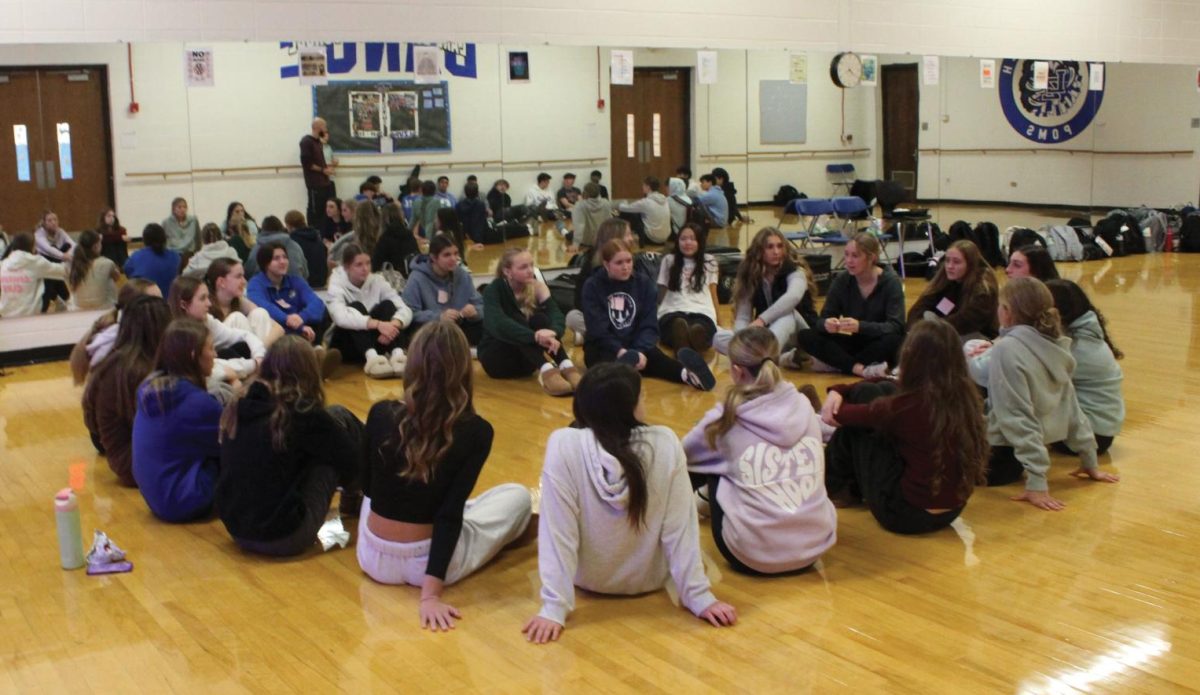 Members of the Fellowship of Christian Athletes playing a name game. Games are typically played at the beginning of the meeting then afterwards a leader shares a lesson with verses from the Bible and leads the group in prayer. 