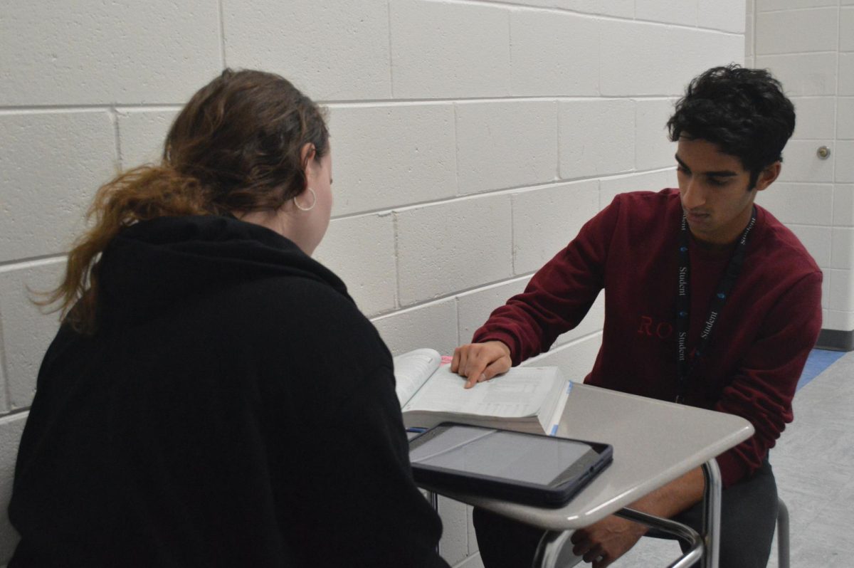 Haravu tutoring a student. According to Haravu, student tutoring is a valuable resource that helps students better understand material in a way that only students who have taken those courses can provide.