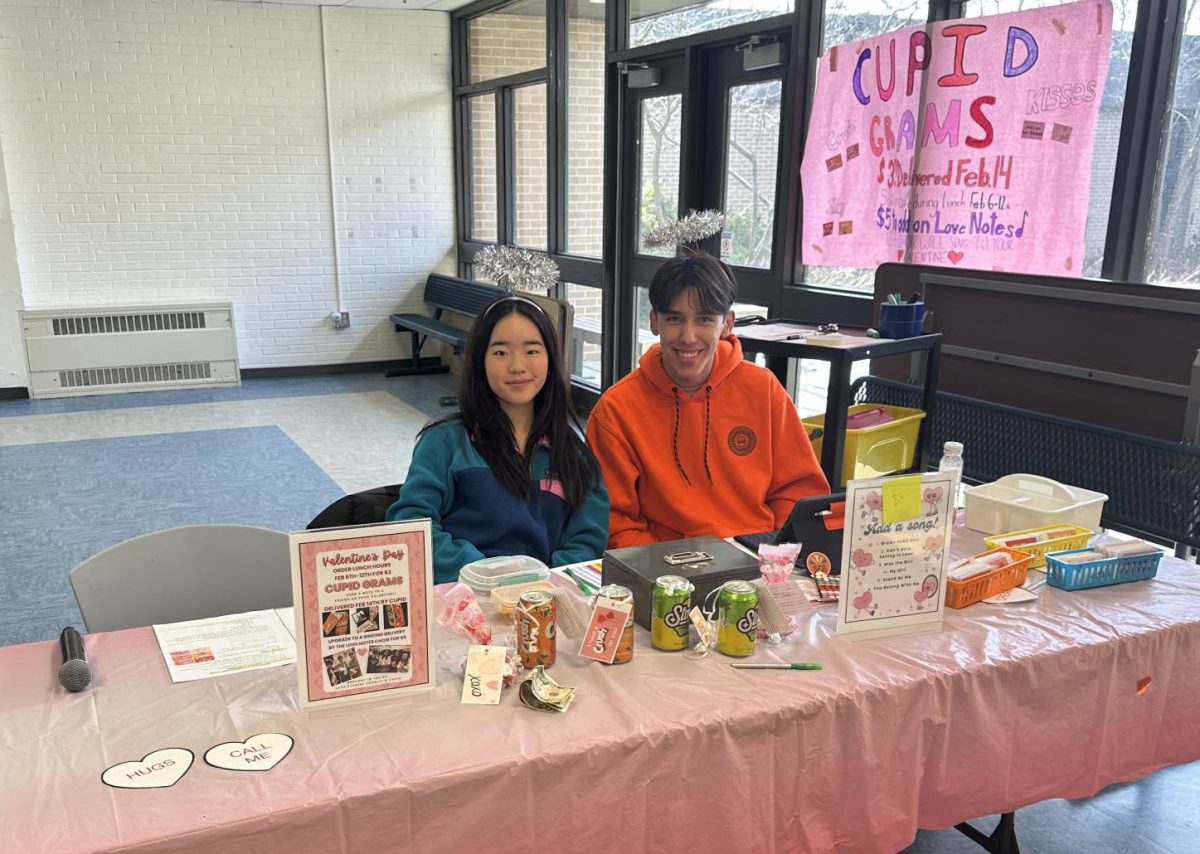 Jeanne Yu and Matteo Gonzalez, both senior student council executives, sit at the Cupid Gram booth during 7th period, where they are being sold from February 6 through 12 during all lunch periods. Once students make an item choice, they can write a small note before passing it off.