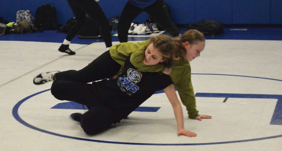 Georgia Hay (forefront) makes history as the first sectional qualifier for the girls wrestling team at LZHS. Some of Hay’s teammates will be alternates for sectionals.
