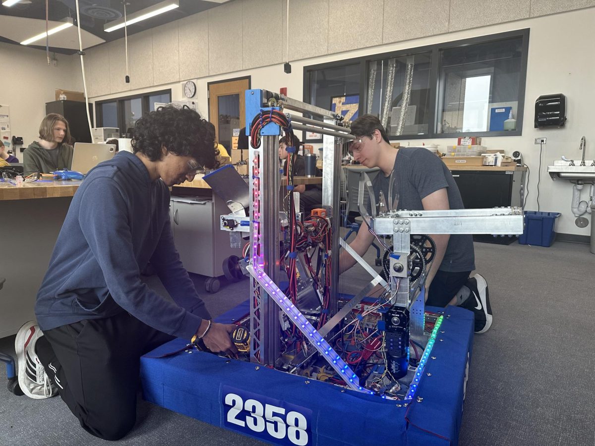 Matthew Nesheim, junior, and Arya Kandaswamy, senior, work on their robot Smokey 18 for the upcoming season. The Robotics team spends countless hours perfecting their robot to meet their goals. 